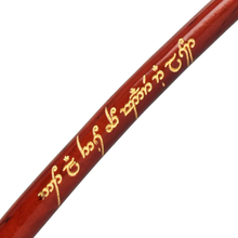 A close-up of a reddish-brown wooden Lord Of The Rings Pipe, engraved with gold Elvish script inspired by J.R.R. Tolkien’s Quenya or Sindarin language.