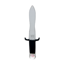 A clear borosilicate glass dagger with a black hilt, curved hand guard, and round translucent pommel. A symbol is etched near the hilt—part of the MJ Arsenal Excalibur Dab Tool collection.
