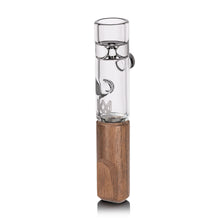 The MJ Arsenal - Alpine Series - Ridge Chillum Taster One Hitter features a cylindrical borosilicate glass chillum atop a rectangular wooden base, standing upright on a white background.