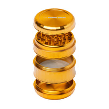 The Human Grade Grinder 6M (2.5") is shown in gold color, separated into four aluminum pieces with grinding teeth, mesh screen, and collection chamber. The ergonomic lid features the HUMAN GRADE label.