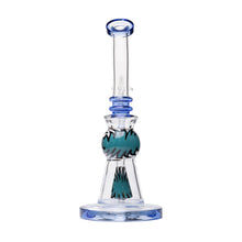 The Human Grade 10" Mini Gumball Rig Glass Water Pipe is a clear borosilicate dab rig featuring blue accents and a teal and black zigzag pattern on the midsection, standing upright on a round base.