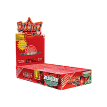A display box of Juicy Jay's Flavored Papers in strawberry, with vibrant red packaging featuring strawberry images and promotional text. The open box shows individual packs, each triple-dipped for extra flavor.