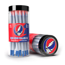 A clear plastic jar labeled Blazy Susan x Grateful Dead Cones holds blue and white pre-rolled cones. The jar and lid display the Grateful Dead “Steal Your Face” skull on a red background, with one jar upright and another lying down.