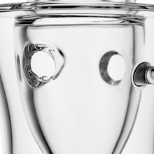 Close-up of the MJ Arsenal Bloopcycler Dab Rig, showcasing its shiny, reflective metal with two round holes and smooth curves, creating distorted reflections and highlights for an elevated dabbing experience.