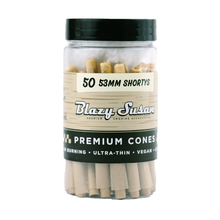 A clear plastic jar labeled Blazy Susan Unbleached Paper Cones holds 50 53mm Shortys. The label highlights slow-burning, ultra-thin, vegan cones—ideal for fans of unbleached pre-rolled options.
