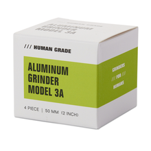 A white and green box labeled Human Grade Grinder 3A (2" 4-Piece), featuring text "Human Grade" and "Grinders for Humans" on the sides.