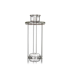 A clear, cylindrical borosilicate glass container with a narrow neck and flat, wide rim features simple, symmetrical detailing at the base and neck reminiscent of the MJ Arsenal Piston Gravity Bong. Photographed on a white background.