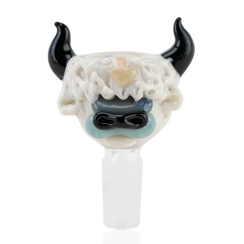 The Empire Glassworks Appa Bowl is a hand-crafted piece shaped like a stylized creature's face, with large black horns, white textured fur, blue eye accents, and a frosted white base connector.